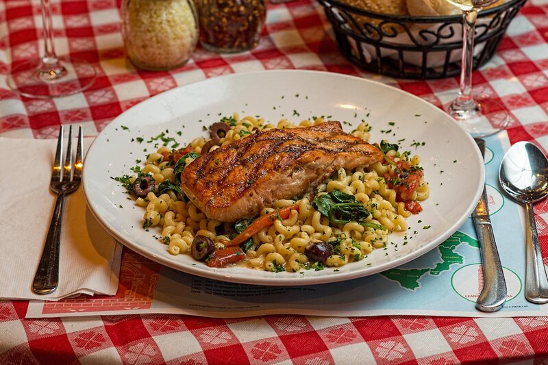 Salmon on a bed of pasta and vegetables