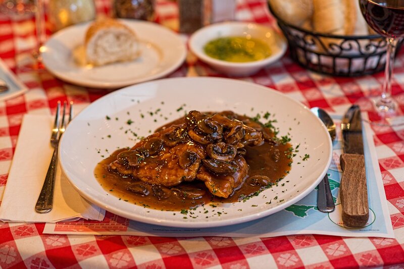 Chicken entree topped with mushrooms in a brown sauce