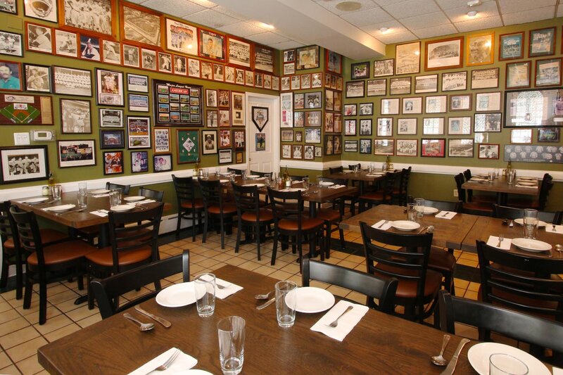 Side dining room with brown wood top tables and baseball memorabilia decorations