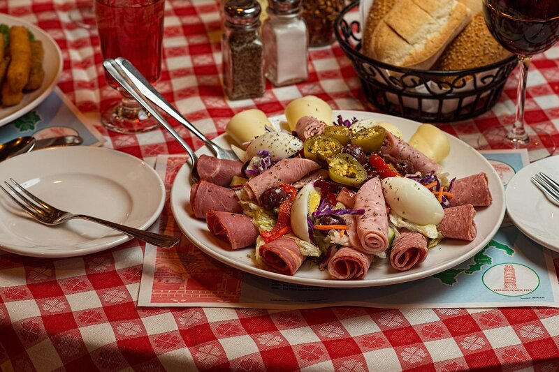 Antipasta salad with bread and glass of red wine