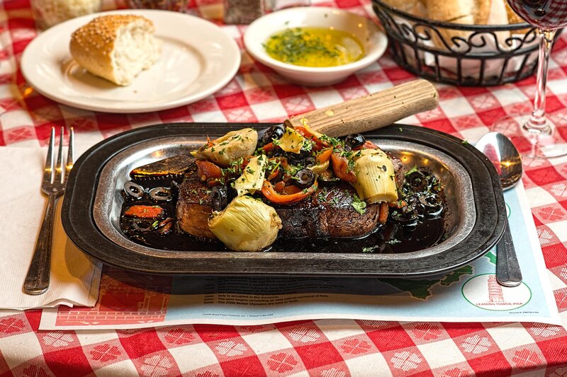 NY sirloin steak with roasted peppers, sliced black olives, and artichoke hearts in balsamic vinegar